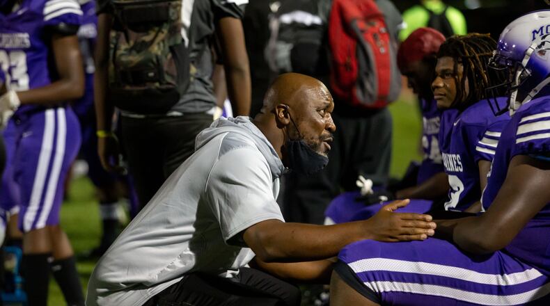 Miller Grove coach Melvin Brown talks with a player during a GHSA high school football game between Stephenson High School and Miller Grove High School at James R. Hallford Stadium in Clarkston, GA., on Friday, Oct. 8, 2021. (Photo/Jenn Finch)