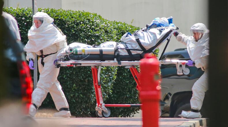 In 2014, Emory University Hospital took in the nation’s first two patients infected with the Ebola virus, and it cured them in an isolation unit that officials had been preparing for a decade. Here, the second patient, Nancy Writebol, was wheeled in to the hospital. Georgia has some of the nation’s most important public health institutions, but as a state, it ranks as average in public health security and preparedness in a recent study. (PHOTO: MANDATORY CREDIT / JOHN SPINK/JSPINK@AJC.COM)