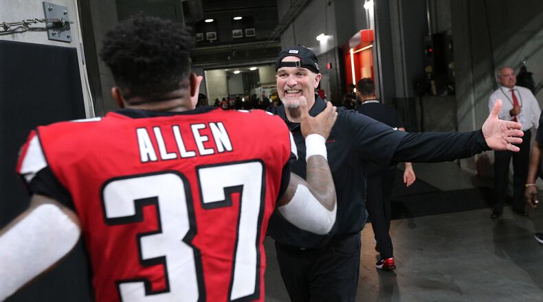 Falcons head coach Dan Quinn and safety Ricardo Allen celebrate a 24-20 victory over the Philadelphia Eagles.  Curtis Compton/ccompton@ajc.com