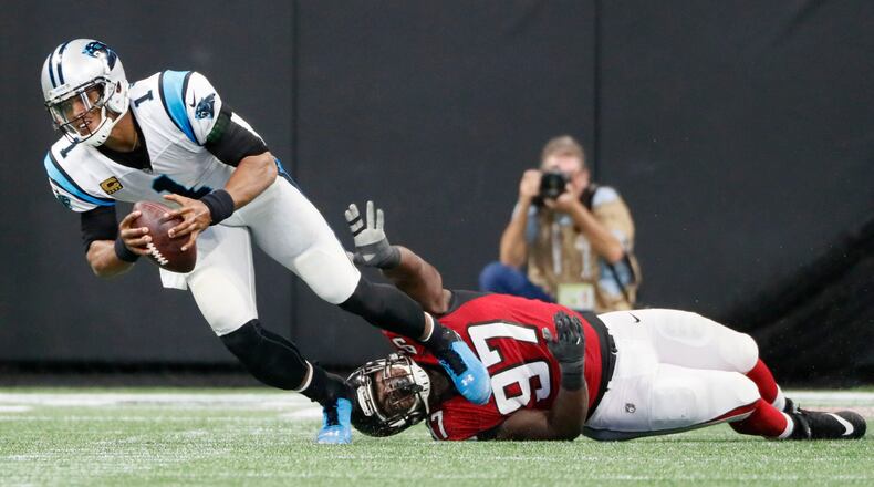Atlanta Falcons defensive tackle Grady Jarrett (97) trips up Carolina Panthers quarterback Cam Newton (1) forcing an incomplete pass Sunday, Sept 16, 2018, at Mercedes-Benz Stadium in Atlanta.