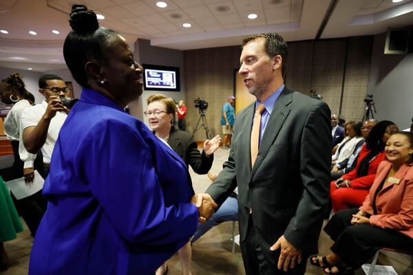 Atlanta City Council President Doug Shipman congratulates Danielle Battle after she is sworn in as the interim superintendent for Atlanta Public Schools on Monday, Aug. 28, 2023. (Miguel Martinez /miguel.martinezjimenez@ajc.com)