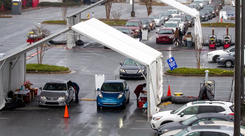 Cars line up to receive their covid 19 vaccine shots at a vaccination center in Doraville Monday. January 11, 2021 
 STEVE SCHAEFER FOR THE ATLANTA JOURNAL-CONSTITUTION
