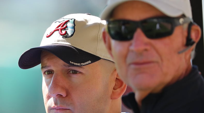 Braves general manager John Coppolella (left) and president of baseball operations John Hart watched a spring-training workout in February. They’ve steered the Braves’ rebuilding project over the past two years. (Curtis Compton/ccompton@ajc.com)