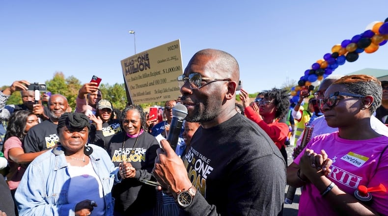 Pricilla Ward (left) is recognized by New Birth Senior Pastor Dr. Jamal Bryant as being the millionth person served by The King’s Table. The church presented Ward with a $1,000 check, additional small appliances and free groceries on Oct. 15.