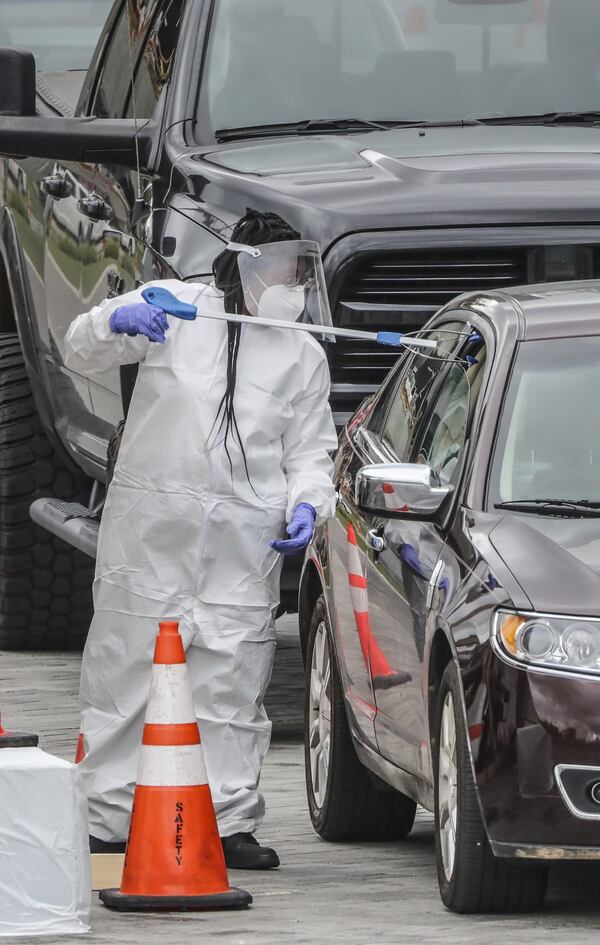 Core workers used grabbing tools to exchange materials with patients to be tested on Thursday, April 30, 2020 at the Home Depot Backyard. Los Angeles-based CORE Response and the Arthur M. Blank Family Foundation on Thursday opened a coronavirus testing site at Mercedes-Benz Stadium. The testing center is at the Home Depot Backyard adjacent to the stadium, offered free tests to people with appointments from 10 a.m. to 4 p.m. The site will operate Monday-Friday for at least the next several weeks. David Boden, a volunteer with CORE, said the nonprofit, founded by actor Sean Penn, has operated about a half-dozen sites in southern California. The center will offer both drive-through and walk-up service. Tests are self-administered via an oral swab and those tested will be contacted by the testing company with results. State Rep. Mark Newton, R-Augusta, a physician who helped arrange the testing site, said it will serve people with COVID-19 symptoms, health workers, first responders as well as asymptomatic food service workers. Workers who are sick are not permitted to return to work, under the new restaurant rules, but it’s also known that asymptomatic people carry the virus. Newton said that this center will help food workers know if they have the virus, even if they show no signs, offering assurance to their employers, co-workers and patrons. JOHN SPINK / JSPINK@AJC.COM