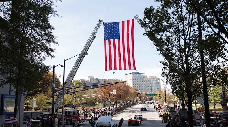 A large flag hangs over Baker Street during The Georgia Veterans Day Parade in downtown Atlanta Saturday, November 11, 2017.