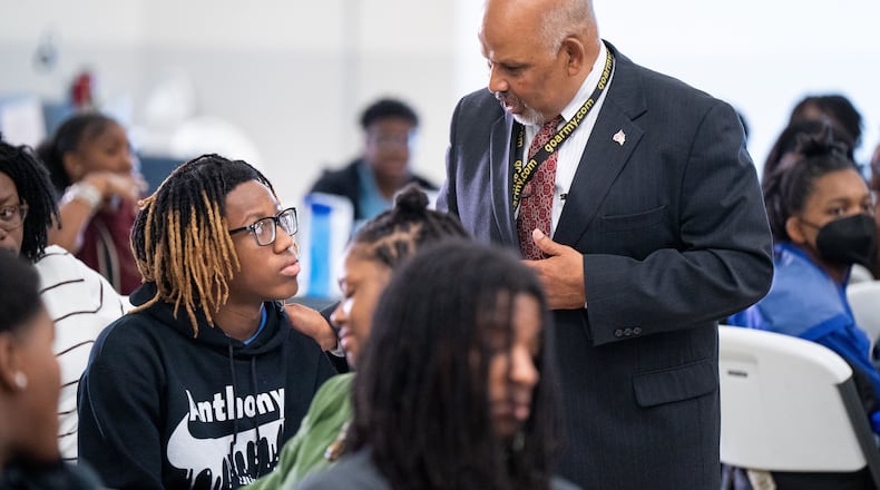 Hartsfield-Jackson International Airport general manager Balram Bheodari speaks with a student. The airport is kicking off its summer youth programs.