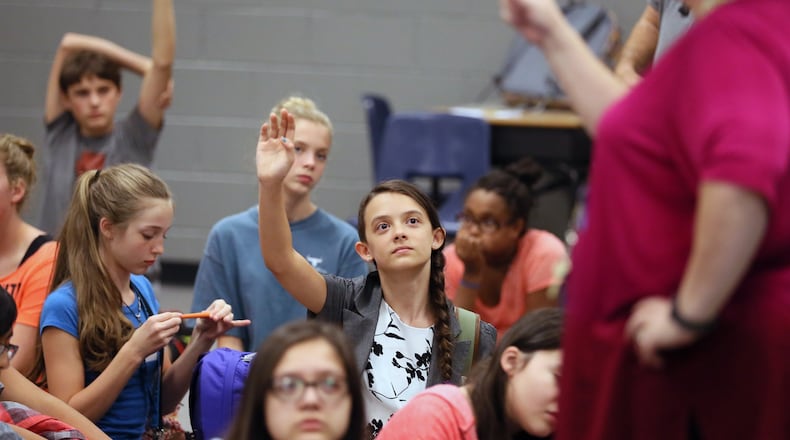 Ellie Kessler raises her hand at a session at Lanier Middle School in Sugar Hill beginning an annual project for a select number of eight graders under the school’s TWIST program. TWIST stands for Teamwork With Innovative Skills & Technology. The school is kicking off a program to involve more girls in science, technology, engineering and math courses. Georgia, like the rest of the nation, is struggling with an academic gender gap in science and math. BOB ANDRES /BANDRES@AJC.COM