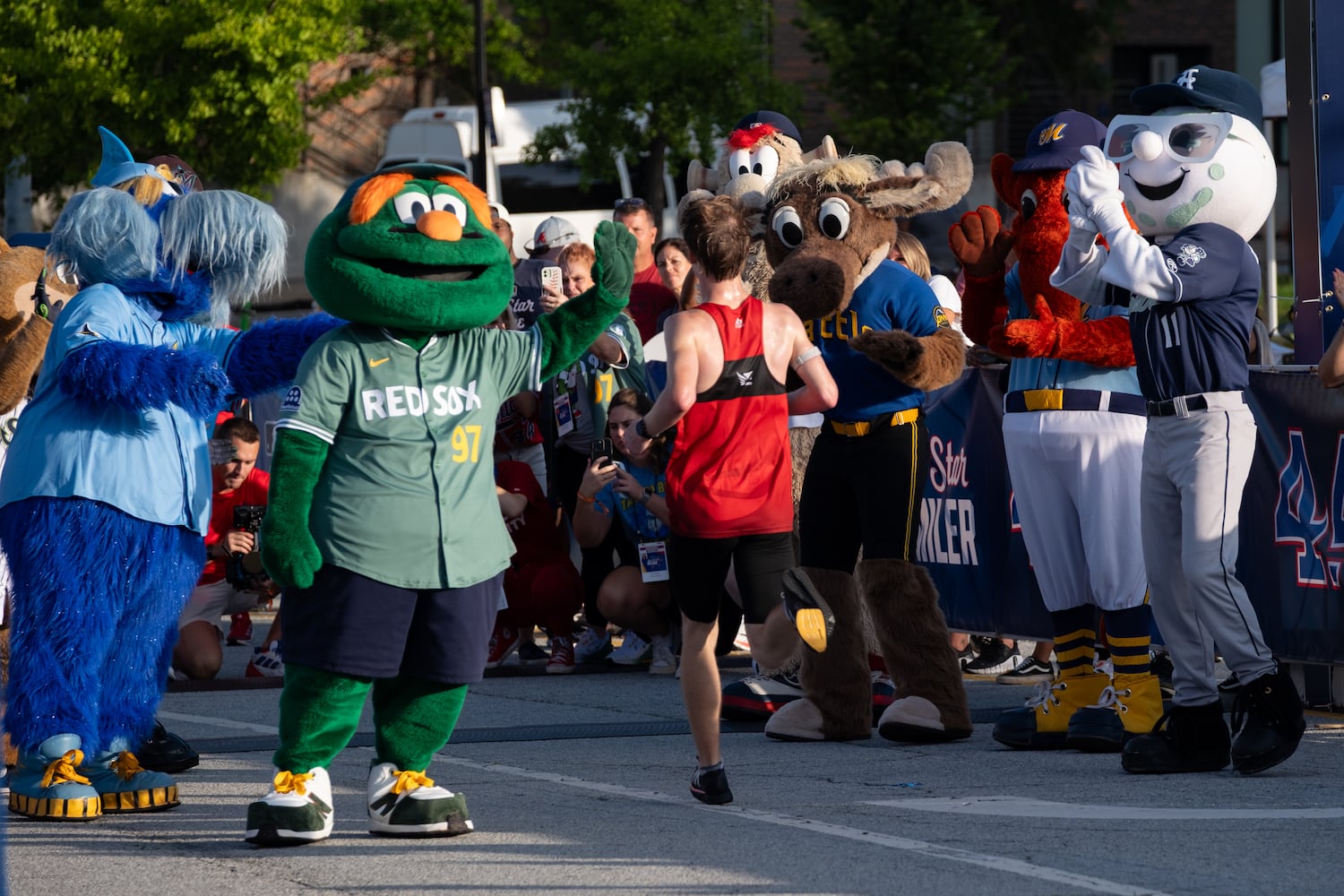 Will Ponder is cheered by MLB mascots as he wins the MLB All-Star 4.4 Miler in Atlanta on Sunday, July 13, 2025.   Ben Gray for the Atlanta Journal-Constitution