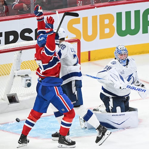 Montreal Canadiens' Kirby Dach (77) reacts to a goal by teammate Lane Hutson against Tampa Bay Lightning goaltender Andrei Vasilevskiy (88) during overtime in an NHL hockey playoff game in Montreal, Friday, April 24, 2026. (Graham Hughes/The Canadian Press via AP)