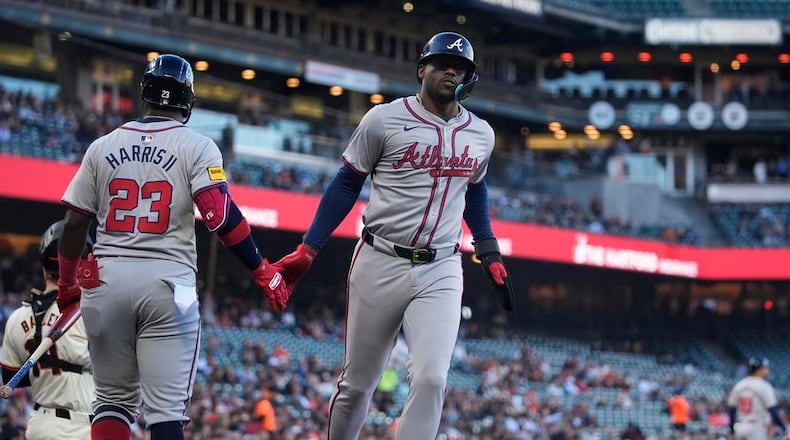 Atlanta Braves' Jorge Soler, right, celebrates with Michael Harris II (23) after scoring against the San Francisco Giants during the first inning of a baseball game Wednesday, Aug. 14, 2024, in San Francisco. (AP Photo/Godofredo A. Vásquez)