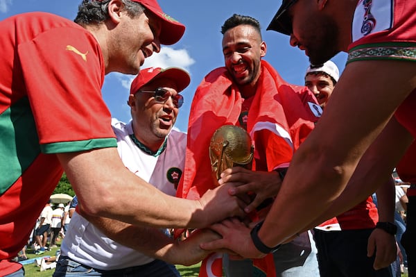 Local Moroccan fans, including (from left) Chakib Assif and Elmamoune Fakri, cheer as they gather for a watch party ahead of the match against Brazil at the FIFA Fan Festival in Centennial Olympic Park on Saturday, June 13, 2026, in Atlanta. (Hyosub Shin/AJC)