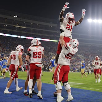 Nebraska running back Emmett Johnson (21) is lifted into the air by Nebraska linebacker Christian Jones (50) after Nebraska scored a touchdown against UCLA during the second half of an NCAA college football game Saturday, Nov. 8, 2025, in Pasadena, Calif. (AP Photo/Ethan Swope)