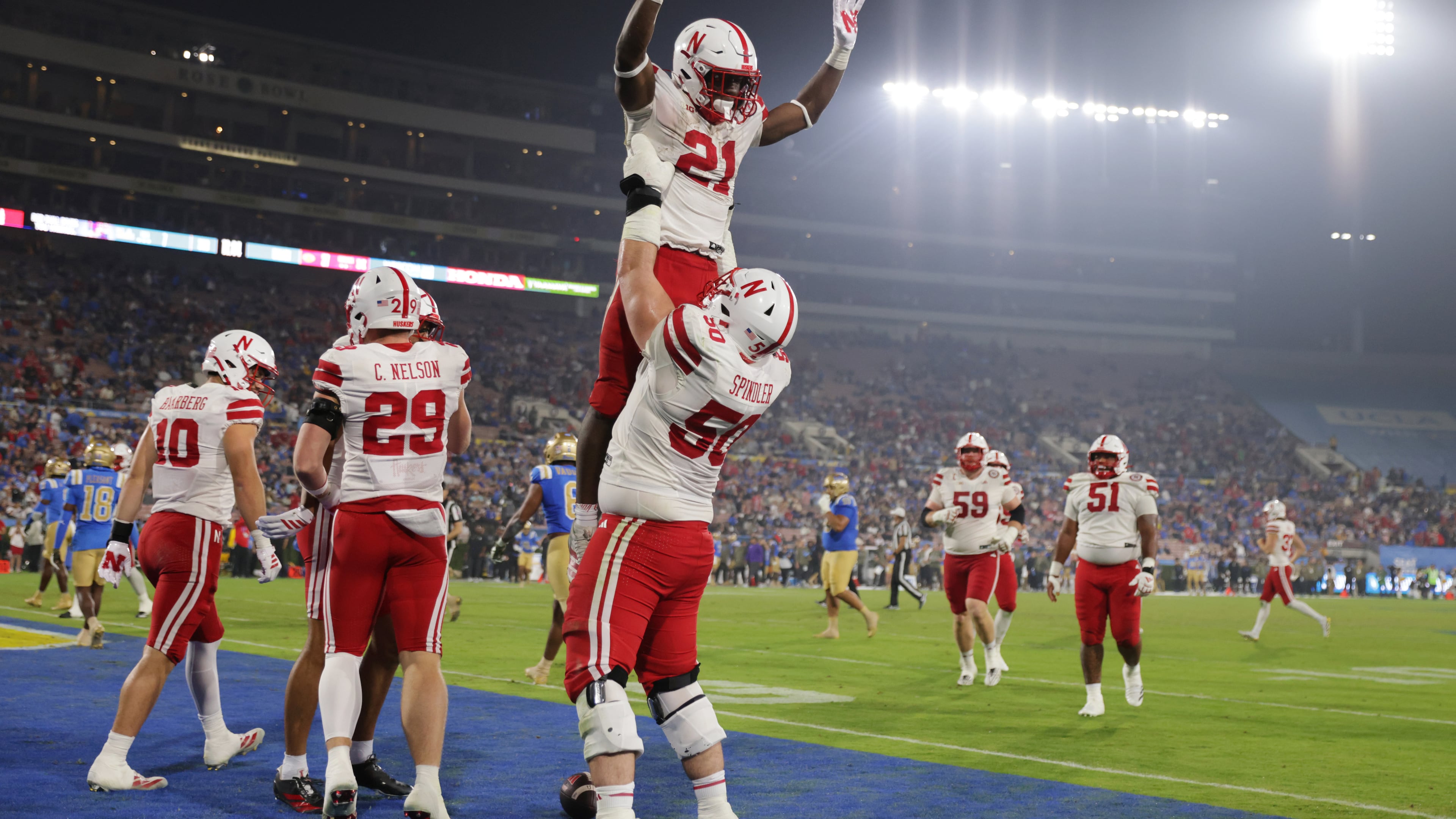 Nebraska running back Emmett Johnson (21) is lifted into the air by Nebraska linebacker Christian Jones (50) after Nebraska scored a touchdown against UCLA during the second half of an NCAA college football game Saturday, Nov. 8, 2025, in Pasadena, Calif. (AP Photo/Ethan Swope)