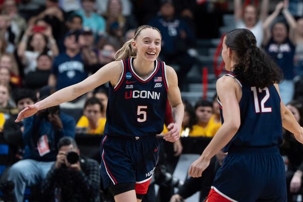 UConn guards Paige Bueckers (5) and Ashlynn Shade (12) reacts after a game against Southern California in the Elite Eight of the NCAA college basketball tournament Monday, March 31, 2025, in Spokane, Wash. (AP Photo/Jenny Kane)