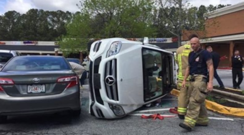 A woman flipped her car in an Atlanta grocery store parking lot. (Mike Petchenik via Twitter / WSB)
