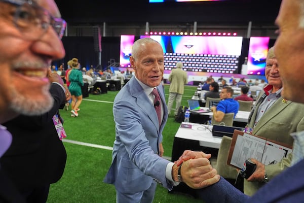 Big 12 Commissioner Brett Yormark, center, greets people before speaking at the Big 12 NCAA college football media days in Frisco, Texas, Tuesday, July 8, 2025. (AP Photo/LM Otero)