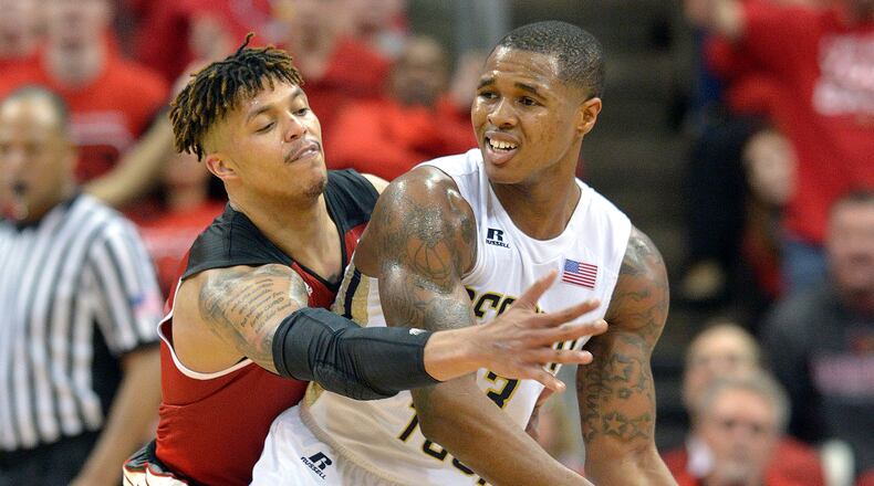 Louisville's Damion Lee (0) attempts to get the ball away from Georgia Tech's Marcus Georges-Hunt (3) during the second half of an NCAA college basketball game, Tuesday, March 1, 2016 in Louisville Ky. Louisville won 56-53. (AP Photo/Timothy D. Easley)
