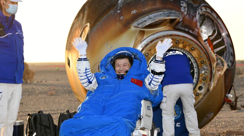 In this photo released by Xinhua News Agency, Wang Jie, a Shenzhou-20 astronaut, returns on the Shenzhou-21 spaceship's return capsule after it touched down on Earth at the Dongfeng landing site in north China's Inner Mongolia Autonomous Region, Friday, Nov. 14, 2025. (Wang Jiangbo/Xinhua via AP)