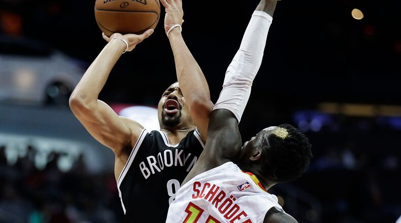 Brooklyn Nets’ Spencer Dinwiddie, left, is fouled by Atlanta Hawks’ Dennis Schroeder as he shoots during the second quarter of an NBA basketball game in Atlanta, Wednesday, March 8, 2017. (AP Photo/David Goldman)