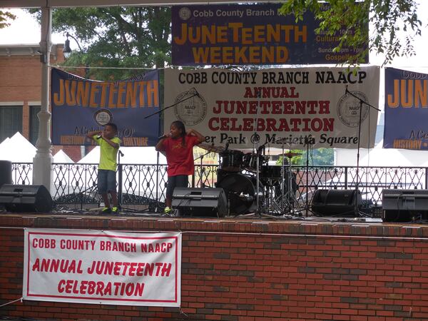 Jaylon (in the green shirt) and Johnny (in red) Gordon perform at the annual Juneteenth celebration. Photo: Jennifer Brett