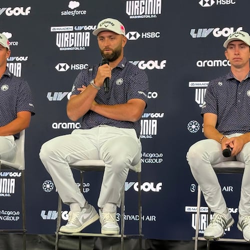 Jon Rahm, flanked by teammates Caleb Surratt, left, and Tom McKibbin, right, takes questions during a LIV Golf news conference in Sterling, Va., Tuesday, May 5, 2026. (AP Photo/Ben Nuckols)