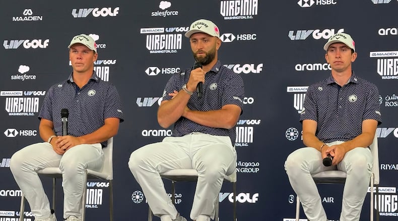 Jon Rahm, flanked by teammates Caleb Surratt, left, and Tom McKibbin, right, takes questions during a LIV Golf news conference in Sterling, Va., Tuesday, May 5, 2026. (AP Photo/Ben Nuckols)