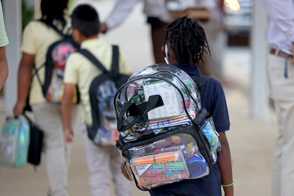 A student wears a mandatory clear book bag as they walk to their classroom during the first day of school for Clayton County public schools at Anderson Elementary School, Wednesday, Aug. 3, 2022, in Conley, Ga. (Jason Getz/AJC)
