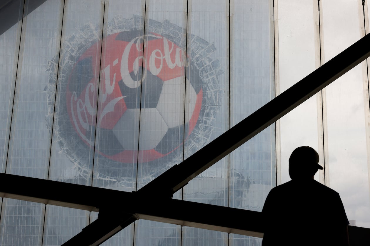 A fan looks at a Coca-Cola advertisement on downtown's Signia by Hilton hotel before the first half of the Czechia vs. South Africa game of the FIFA World Cup at Atlanta Stadium (Mercedes-Benz Stadium) on June 18, 2026. (Arvin Temkar/AJC)