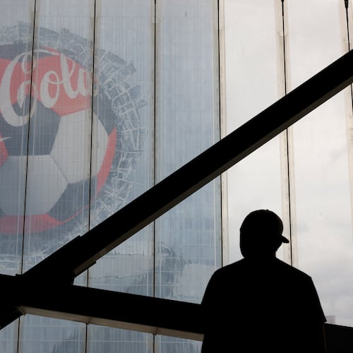 A fan looks at a Coca-Cola advertisement on downtown's Signia by Hilton hotel before the first half of the Czechia vs. South Africa game of the FIFA World Cup at Atlanta Stadium (Mercedes-Benz Stadium) on June 18, 2026. (Arvin Temkar/AJC)