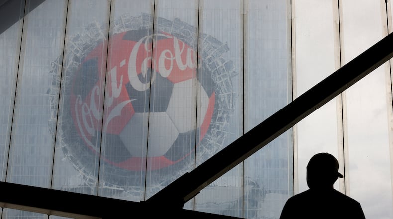 A fan looks at a Coca-Cola advertisement on downtown's Signia by Hilton hotel before the first half of the Czechia vs. South Africa game of the FIFA World Cup at Atlanta Stadium (Mercedes-Benz Stadium) on June 18, 2026. (Arvin Temkar/AJC)