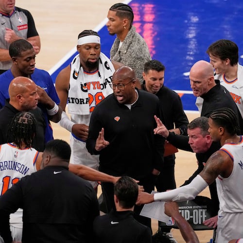 New York Knicks Head Coach Mike Brown, center, talks to his team during the second half of an NBA basketball game against the Cleveland Cavaliers Wednesday, Oct. 22, 2025, at Madison Square Garden in New York. (AP Photo/Frank Franklin II)