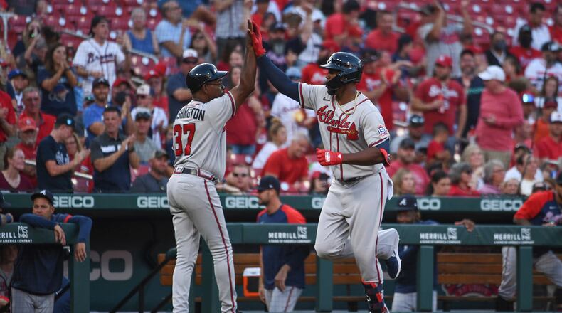 Atlanta Braves' Jorge Soler, right, is congratulated by third base coach Ron Washington after hitting a two-run home run during the first inning of the team's baseball game against the St. Louis Cardinals on Tuesday, Aug. 3, 2021, in St. Louis. (AP Photo/Joe Puetz)