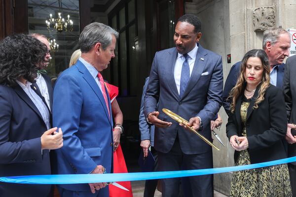 Gov. Brian Kemp and Atlanta Mayor Andre Dickens appear for a ribbon cutting at the opening of the affordable housing and transitional program run by Georgia Works in April. (Arvin Temkar/AJC)