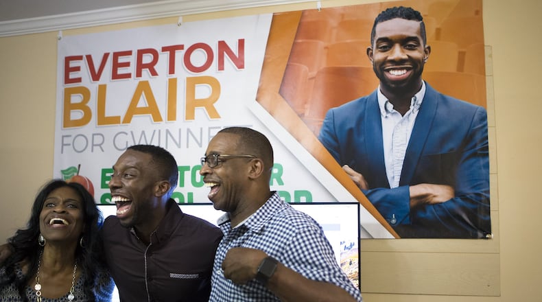 Everton “EJ” Blair Jr. laughs with his parents while taking a picture on Nov. 6, 2018, when he won the District 4 seat on the Gwinnett County Board of Education. CASEY SYKES FOR THE ATLANTA JOURNAL-CONSTITUTION