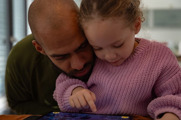 Kasim Edebali and his daughter Yara play a game on a tablet, in Hamburg, Germany. (Patrick Junker/The New York Times 2023)