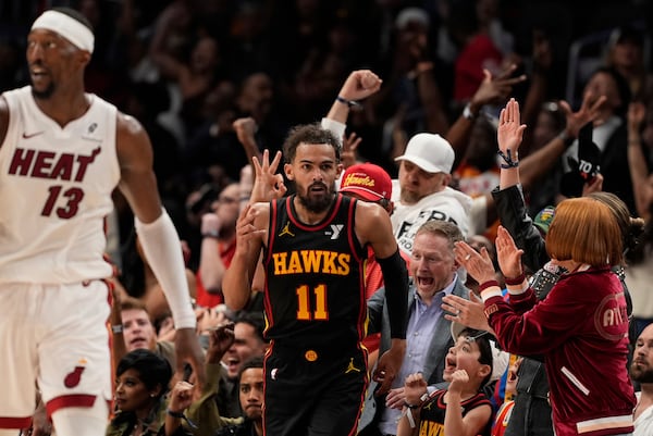 Hawks guard Trae Young (11) celebrates after scoring in overtime of an NBA Play-In Tournament basketball game against the Miami Heat on Friday, April 18, 2025, in Atlanta. (Brynn Anderson/AP)