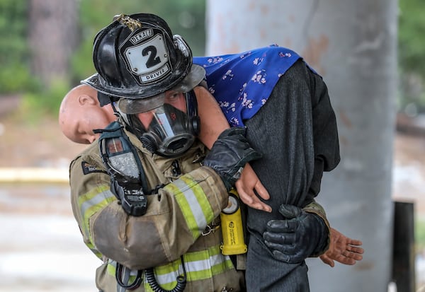 A DeKalb County firefighter participates in a training event in 2023. (John Spink/AJC)

