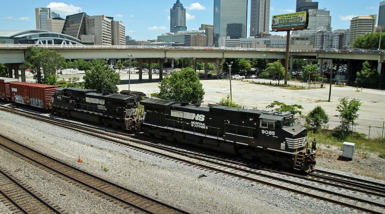 A Norfolk-Southern train travels south close to the Mitchell Street bridge. The Norfolk-Southern route runs north-south through downtown beneath the Georgia World Congress Center (GWCC), through the Gulch, and then onward to parallel MARTA’s Red/Gold lines south of downtown. Residents in southeast Atlanta have complained of long wait times at railway crossings in their neighborhoods. Jason Getz for The Atlanta Journal-Constitution