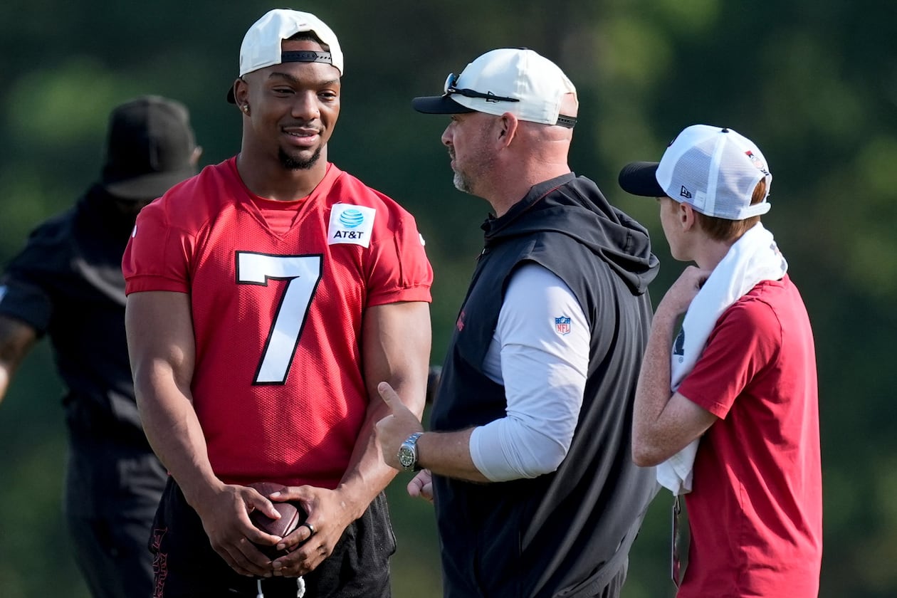 Falcons running back Bijan Robinson (left) is the highest-paid running back in NFL history at $75 million across three years. (Mike Stewart/AP)