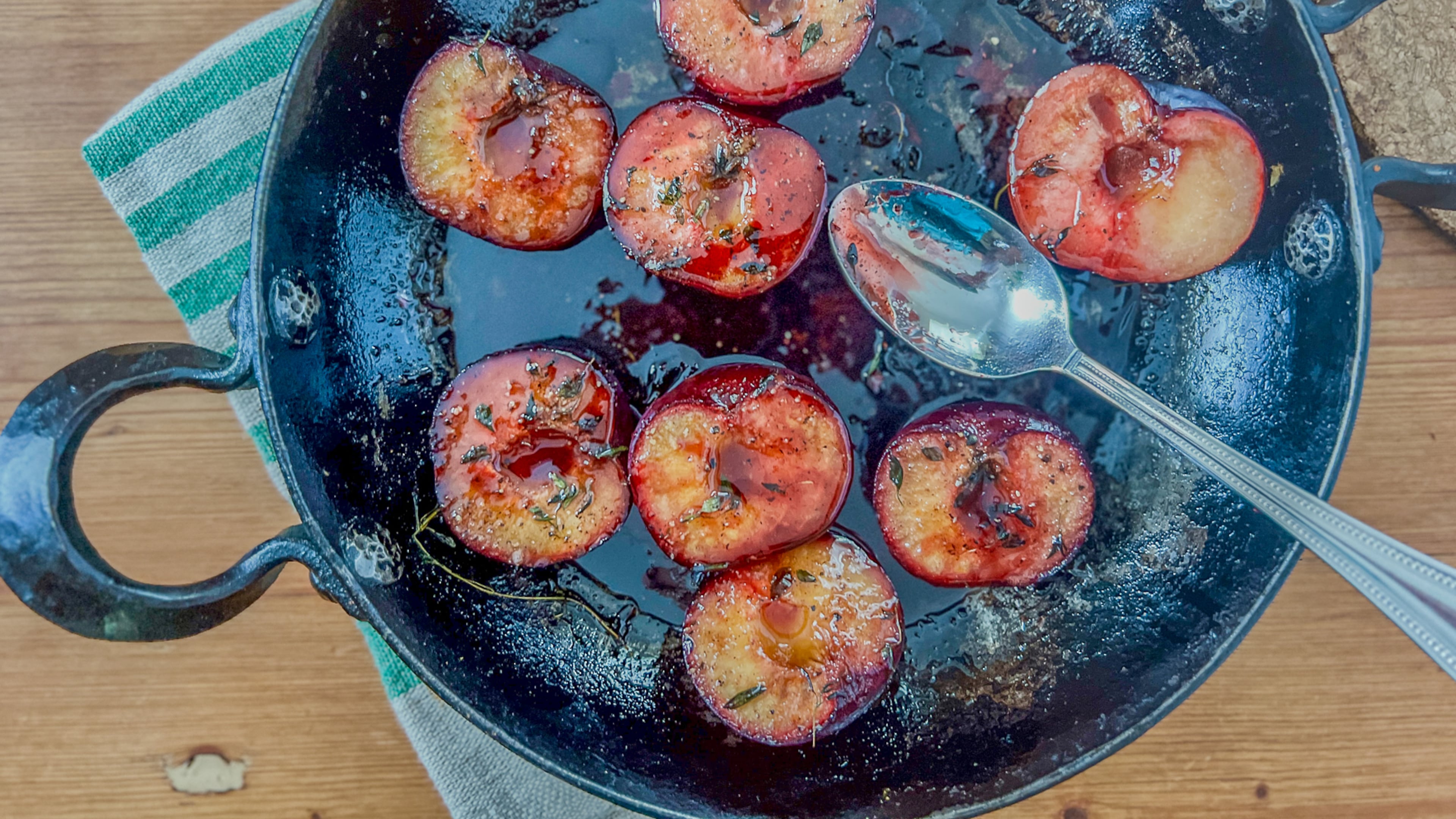 Baked plums with honey, herbs and spices make for a savory side dish. (Virginia Willis for The Atlanta Journal-Constitution)