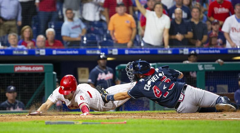 PHILADELPHIA, PA - SEPTEMBER 10: Scott Kingery #4 of the Philadelphia Phillies slides home safely past Francisco Cervelli #45 of the Atlanta Braves for an inside-the-park home run in the bottom of the third inning at Citizens Bank Park on September 10, 2019 in Philadelphia, Pennsylvania. (Photo by Mitchell Leff/Getty Images)