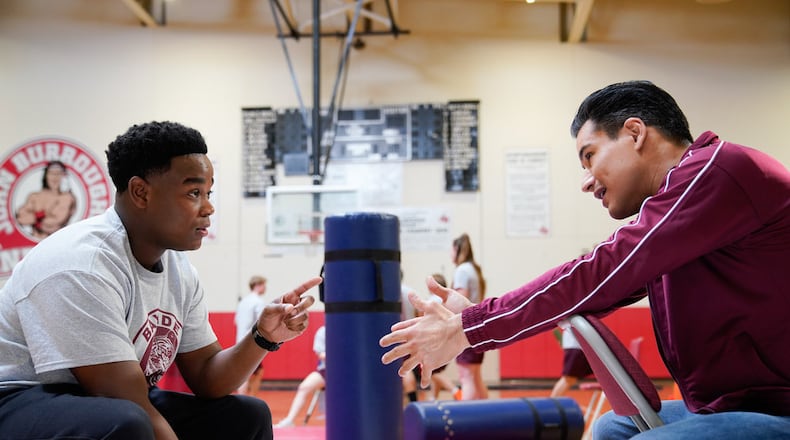 SAVED BY THE BELL -- "Pilot" Episode 101 -- Pictured: (l-r) Dexter Darden as Devante, Mario Lopez as A.C. Slater -- (Photo by: Casey Durkin/Peacock)