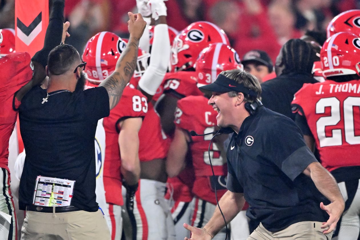 Georgia head coach Kirby Smart reacts as running back Cash Jones (background) celebrates with teammates recovering an onside kick during the second half in an NCAA football game at Sanford Stadium, Saturday, November 15, 2025, in Athens. Georgia won 35-10 over Texas. (Hyosub Shin / AJC)