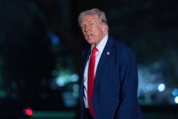 President Donald Trump talks to reporters as he walks on the South Lawn of the White House, in Washington, Sunday, March 30, 2025. (AP Photo/Jose Luis Magana)