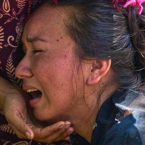 A girl cries as she waits for news of relatives missing after flash floods in Bidur, Nepal's Nuwakot district, Thursday, Aug. 27, 2026. (AP Photo/Niranjan Shrestha)