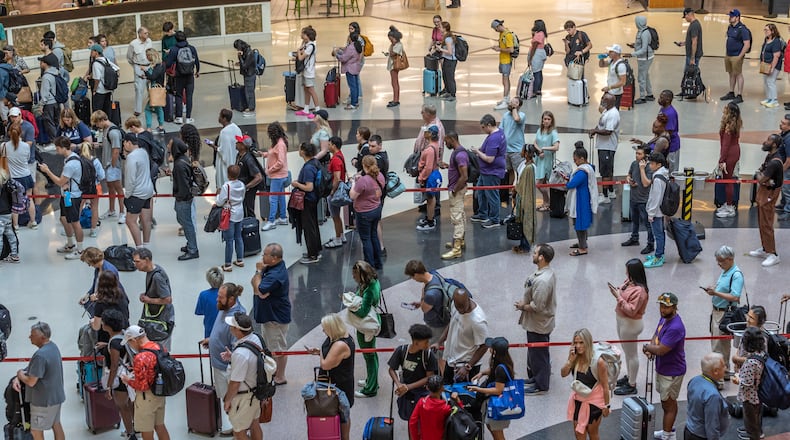 Travelers line up in the domestic terminal atrium waiting to go through security screening at the main security checkpoint at Hartsfield-Jackson International Airport in Atlanta ahead of the Fourth of July holiday, on Friday, June 28, 2024. (John Spink/AJC)