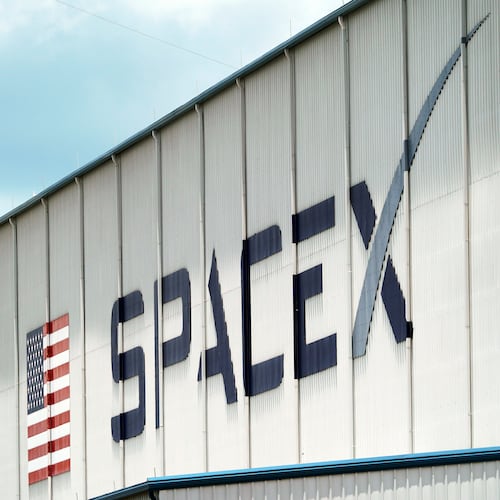 FILE - A SpaceX logo is displayed on a building, May 26, 2020, at the Kennedy Space Center in Cape Canaveral, Fla. (AP Photo/David J. Phillip, File)