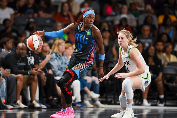 Dream guard Rhyne Howard (left) makes a move against Minnesota Lynx guard Karlie Samuelson at the Gateway Center Arena on Friday, June 27, 2025, in College Park. (Jason Getz/AJC)