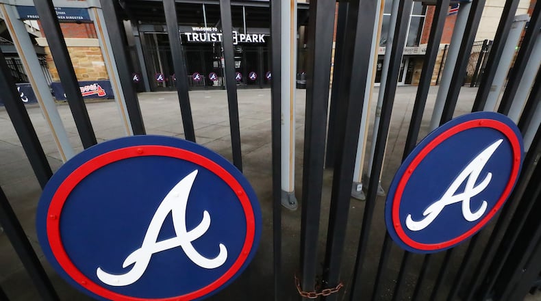 021722 Atlanta: The third base gates to the Atlanta Braves stadium Truist Park are locked up tight during the MLB lockout on Thursday, Feb. 17, 2022, in Atlanta. “Curtis Compton / Curtis.Compton@ajc.com”`